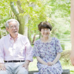 老夫婦が公園で座っている写真